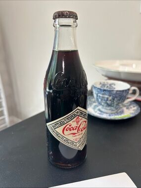 1975 Coca Cola 75th Anniversary commemorative sealed bottle.